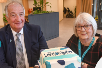 Professor Stephen Leveson with Pat Leveson sat in The Leveson Centre with a cake