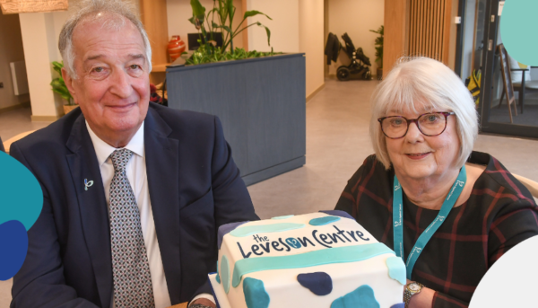 Professor Stephen Leveson with Pat Leveson sat in The Leveson Centre with a cake