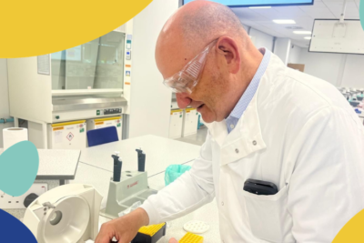 Andy in a lab coat conducting an experiment
