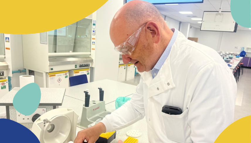 Andy in a lab coat conducting an experiment