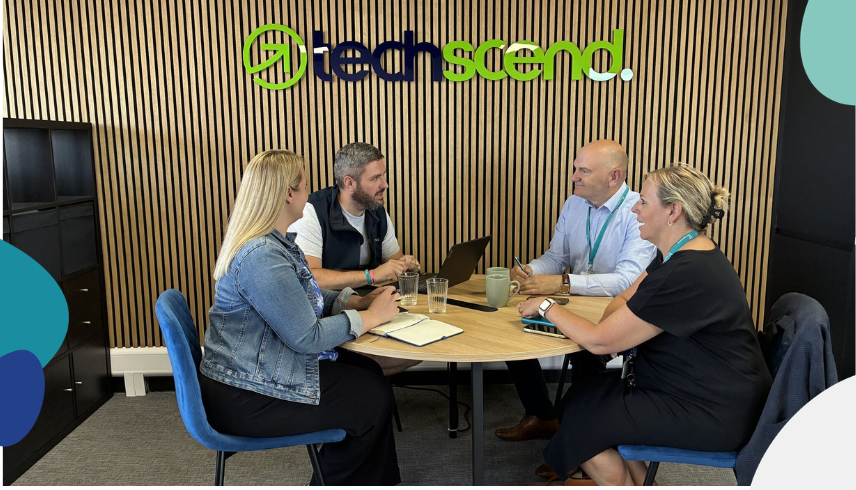 Members of staff from Techscned and York Against Cancer sat around a table